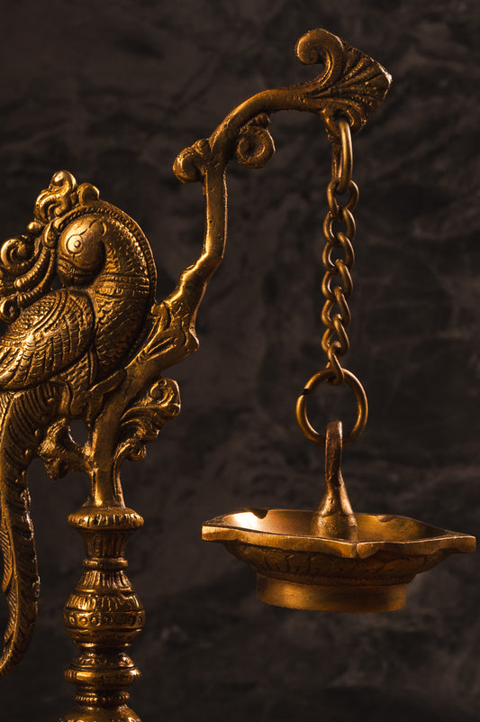 Sacred diya with five oil lights and peacock motif for Vastu harmony